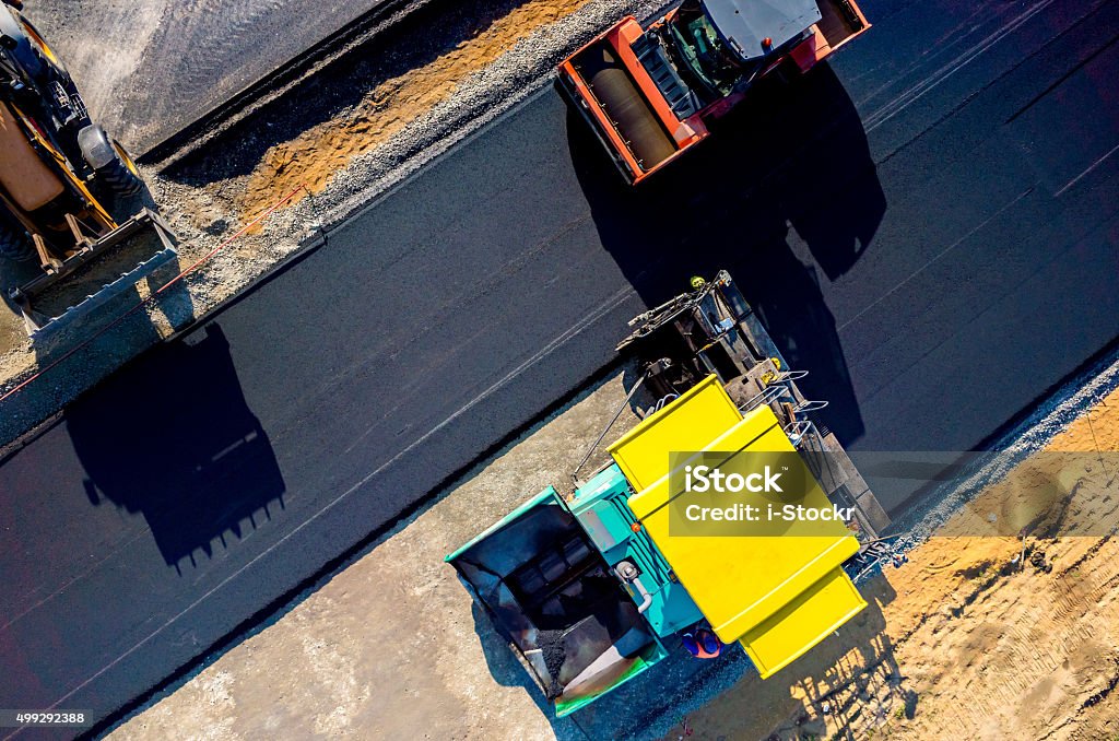 Home aerial view on the new asphalt road under construction