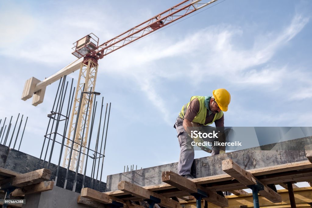 Home worker at construction site is fixing the form for the beam